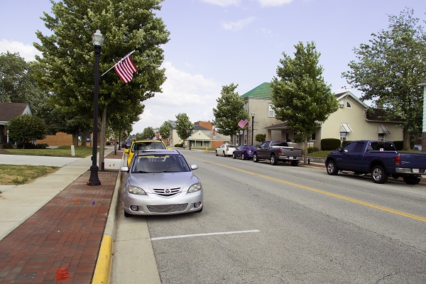 Cars parked along a wide street